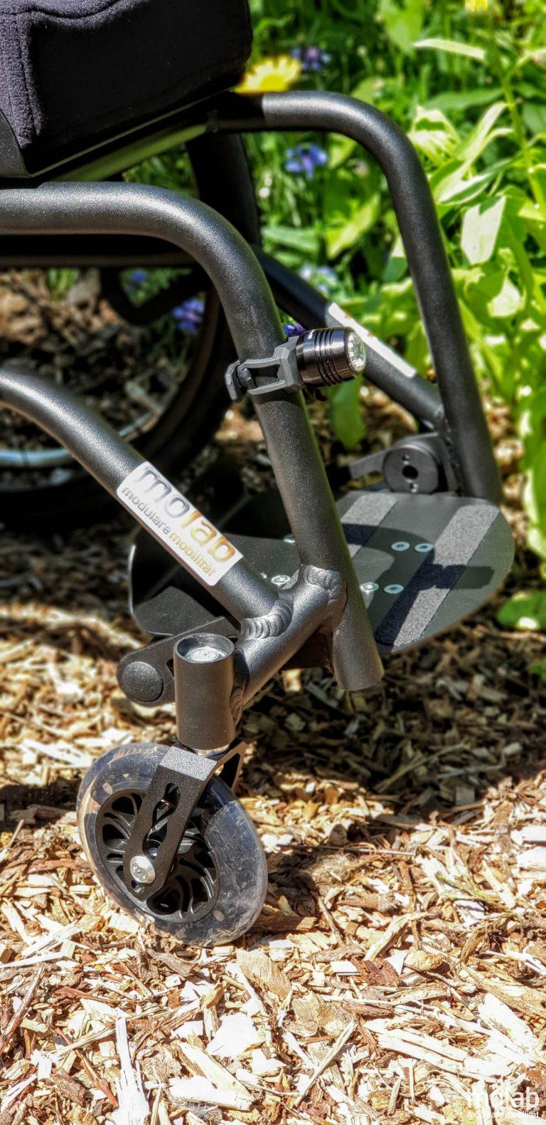 Molab G6KID Rollstuhl im Garten auf Rindenmulch.